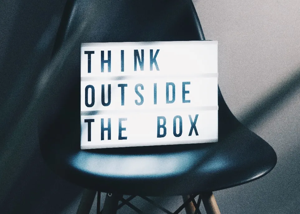 a black chair with neon lights on the seat that reads, think outside the box_plastering and rendering services_gk rend